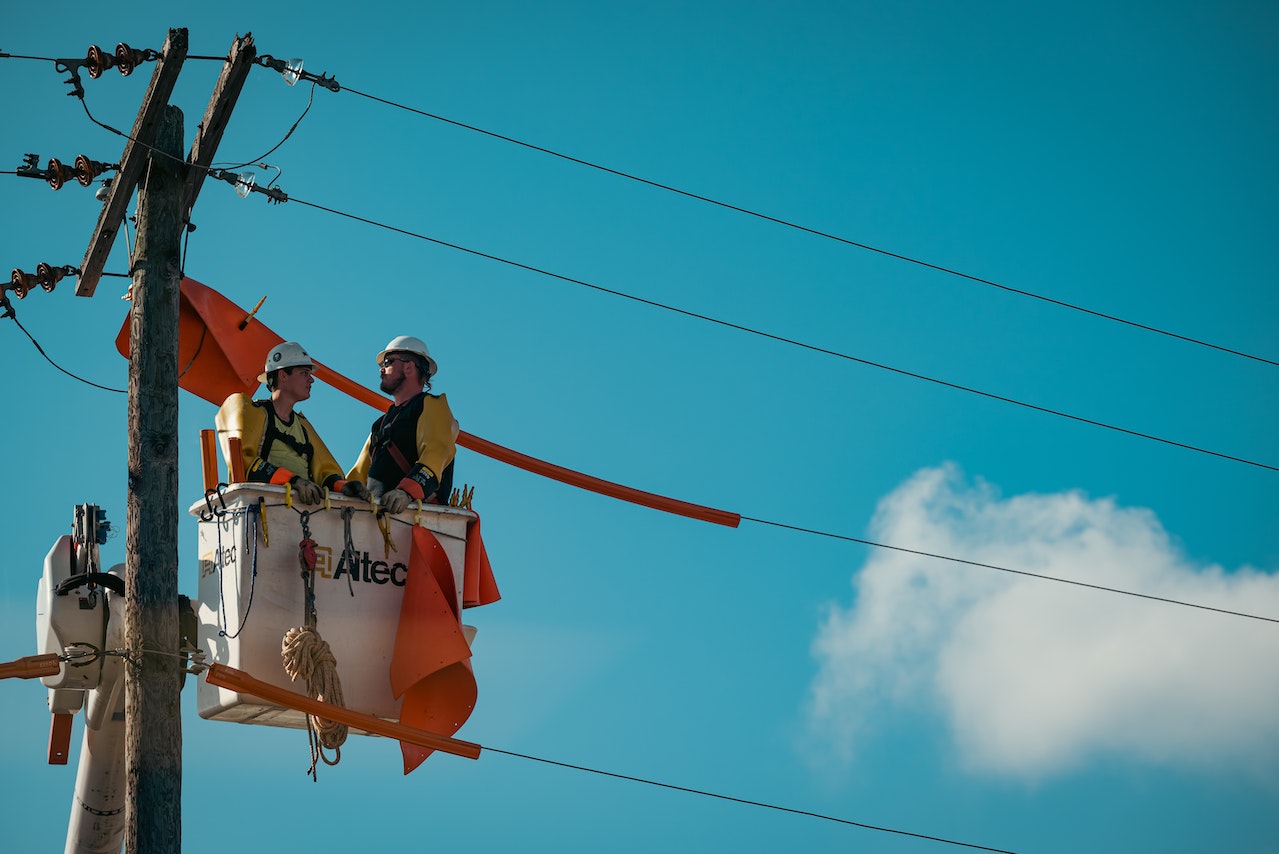 Two Electricians Working on Utility Pole