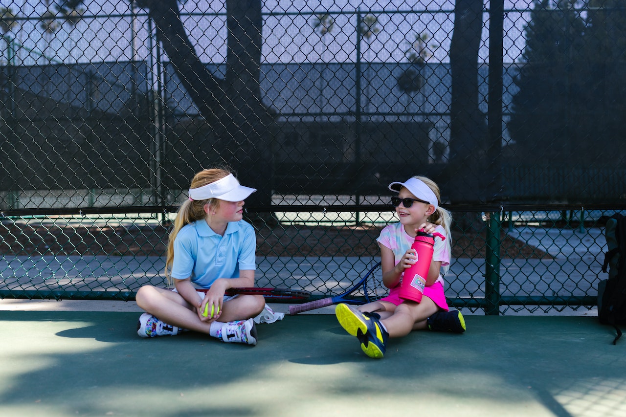 girls at a tennis court
